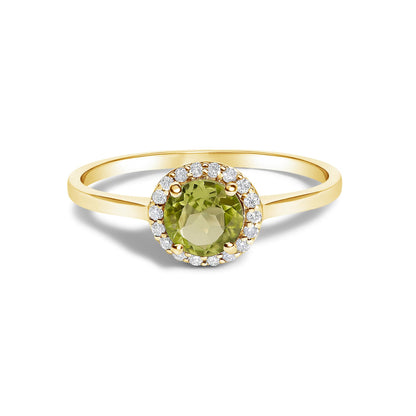 Close-up angled view of a yellow band ring featuring a round green gemstone in a four-prong setting, surrounded by a halo of small round white gemstones in shared prong settings.