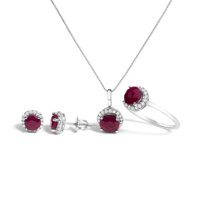 Set of jewelry displayed on a white background, including a pair of stud earrings, a pendant necklace, and a ring. Each piece features a central round red gemstone surrounded by multiple small round white gemstones in a shared prong setting. The image is taken from a front and slightly angled view.