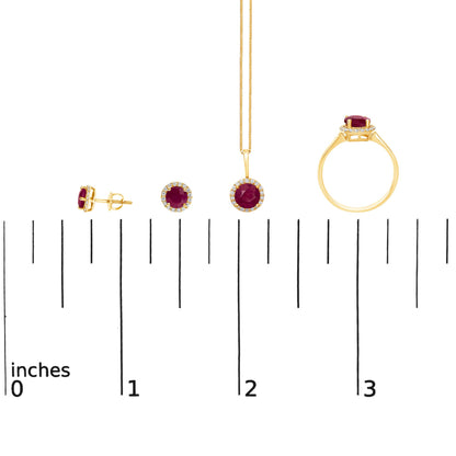 Set of yellow metal jewelry including a ring, necklace pendant on a chain, and stud earrings, each featuring a round red gemstone surrounded by small round white gemstones, shown from side and front angles on a scale.
