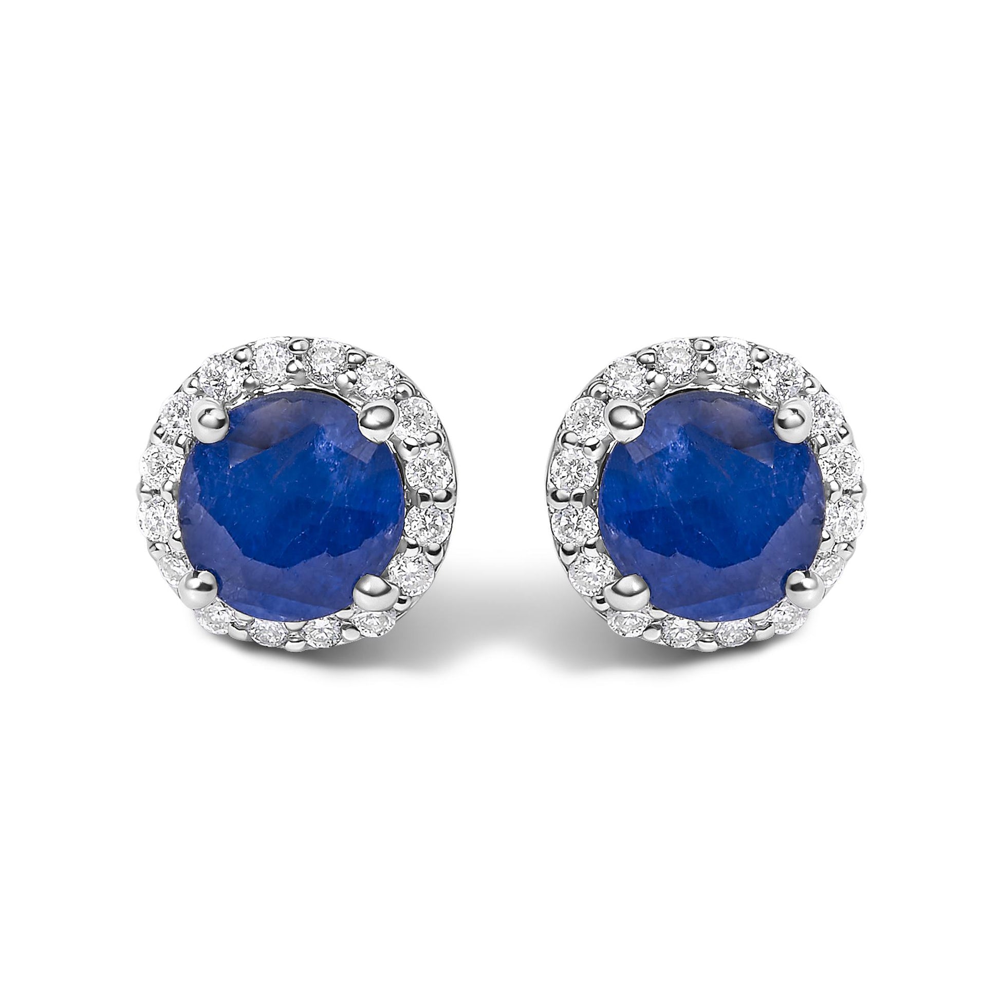 Front view of a pair of round stud earrings featuring a central blue gemstone surrounded by a circle of small white gemstones in shared prong settings.