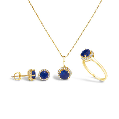Set of yellow jewelry shown on a white background, including a pair of round blue gemstone stud earrings with surrounding white gemstones, a matching round blue gemstone pendant necklace with white gemstone halo, and a yellow ring with a round blue gemstone and white gemstone halo, photographed from a slightly angled front view.