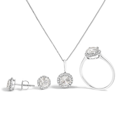 Image showing a white metal jewelry set consisting of a ring, a pendant necklace, and a pair of stud earrings. Each piece features a central round white gemstone surrounded by smaller round white gemstones in a shared prong setting. The set is displayed on a white background from a front-facing angle.