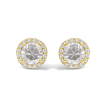 Pair of round stud earrings shown from a front angle, featuring a large central white gemstone surrounded by smaller white gemstones in a shared prong setting on yellow metal.